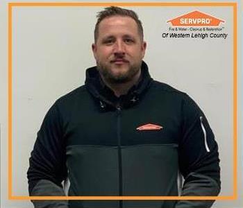Male employee with Black and white SERVPRO Zip up