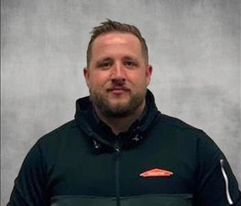 Male employee with Black and white SERVPRO Zip up